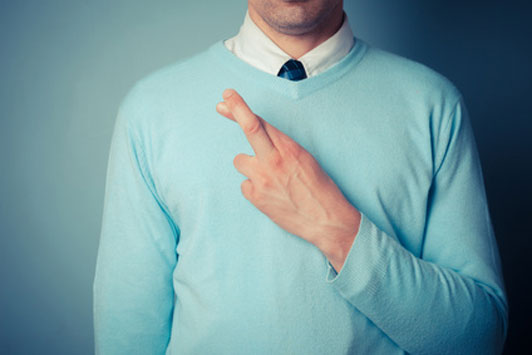 man crossing heart with fingers